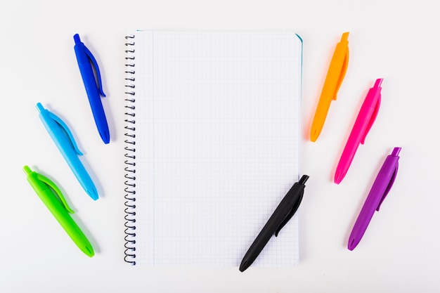 Multi-colored pens with notebook