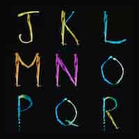 Free photo multi colored water alphabets from j to r on black background