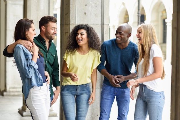 Multi-ethnic group of friends having fun together in urban backg