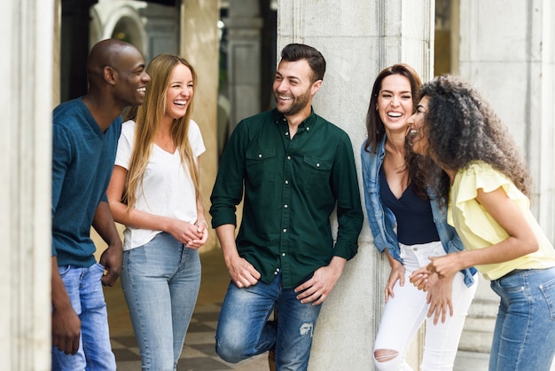 Multi-ethnic group of friends having fun together in urban backg