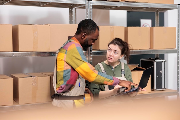 Multi ethnic stockroom supervisor packing parcels