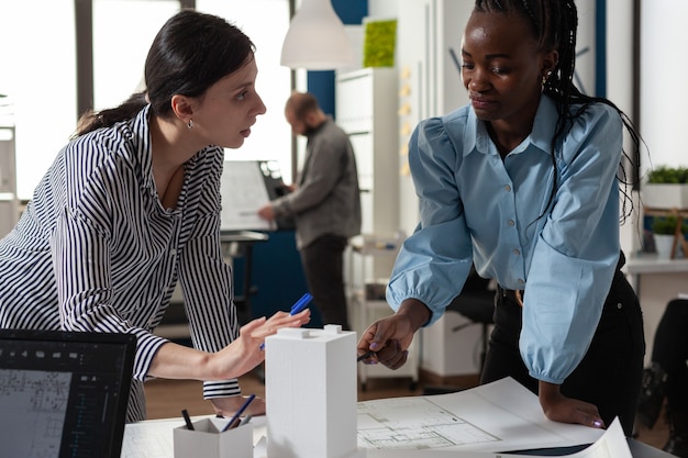 Multi ethnic team of women architects planning project