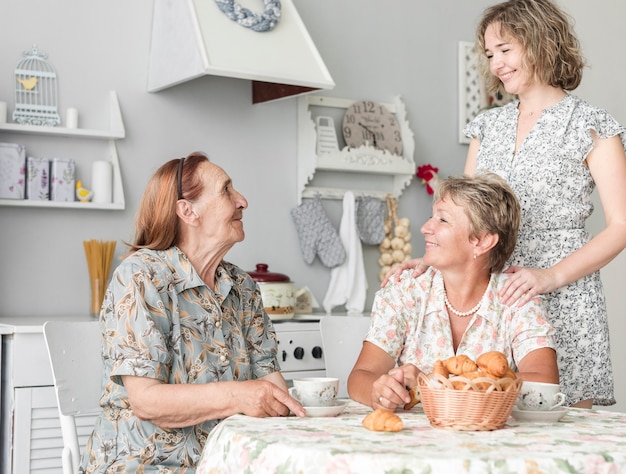 Multi generation women having breakfast in kitchen