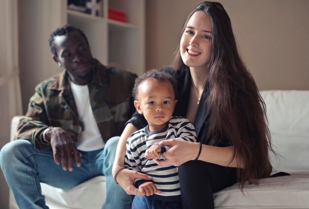 multi-race family sitting on a sofa