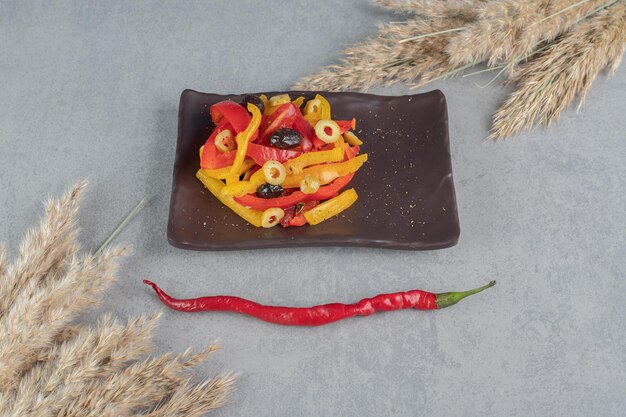 Free photo multicolor bell pepper salad with black and green olives.