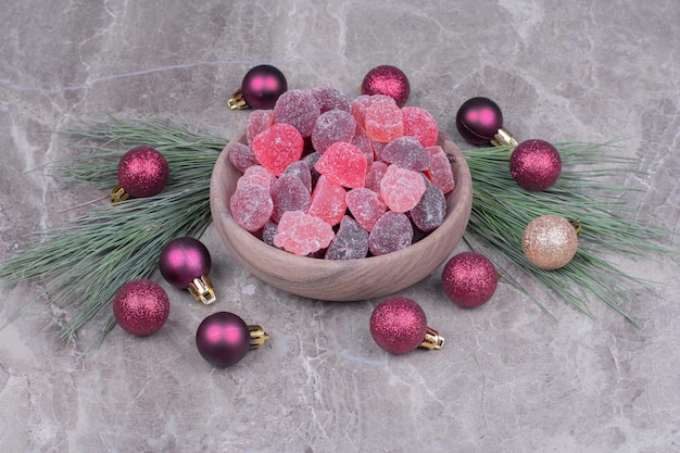 Multicolor jellybeans in a wooden cup on the marble