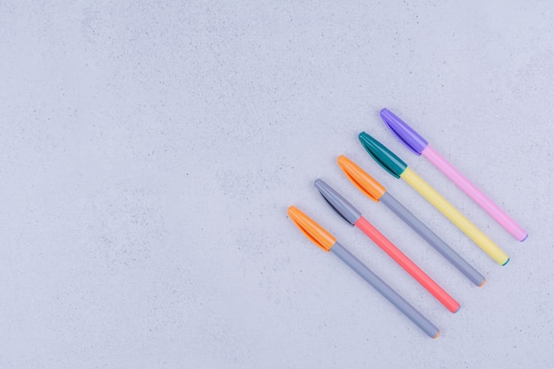 Free Photo  Colorful mandala coloring pens isolated on grey surface