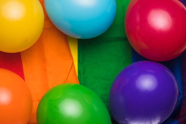 Multicolored balloons on rainbow cloth