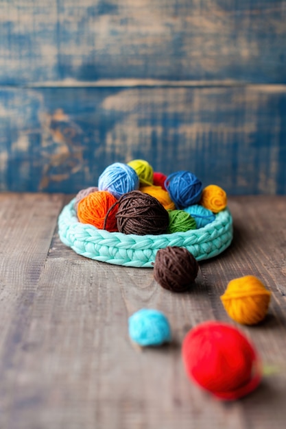 Multicolored balls of yarn in and near the knitted couch