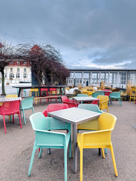 Free photo multicolored chairs on the terrace of a cafe by the sea