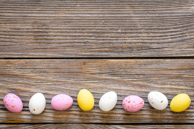 Multicolored Easter eggs on a wooden background flat lay