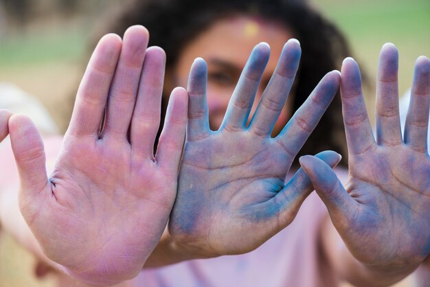 Multicolored hands at holi festival