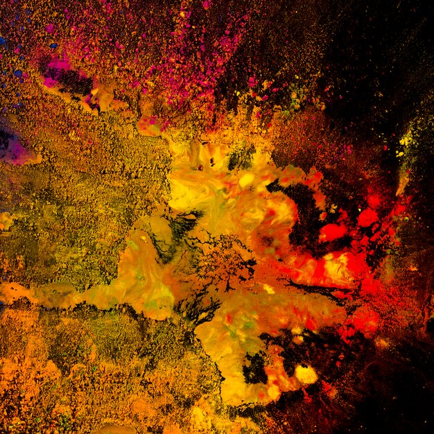 Multicolored holi powder explosion over black backdrop