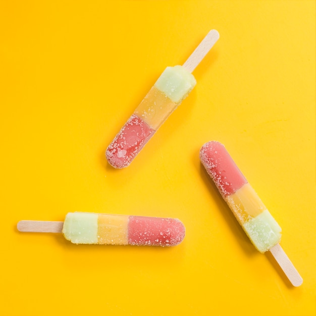 Multicolored identical ice lollies