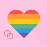 Free photo multicolored lgbt heart and wedding rings