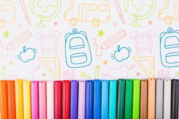 Free photo multicolored markers on painted paper