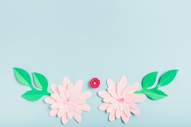 Multicolored paper spring flowers with leaves