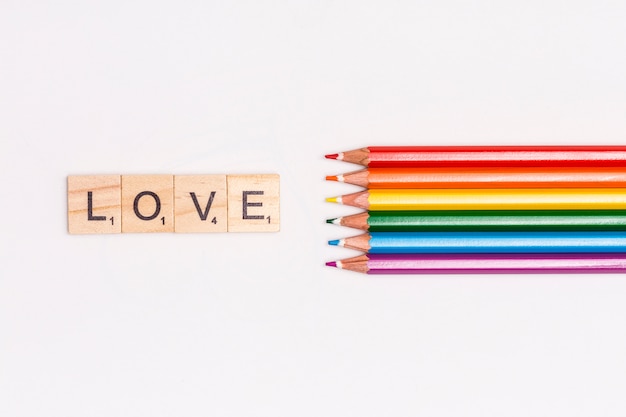 Multicolored pencils and LOVE lettering