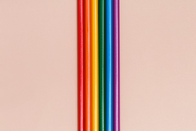 Multicolored rainbow sticks on beige background