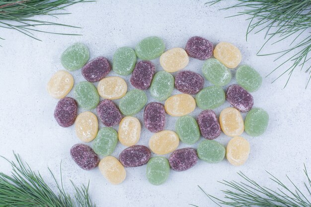 Multicolored sweet marmalades on marble background. 