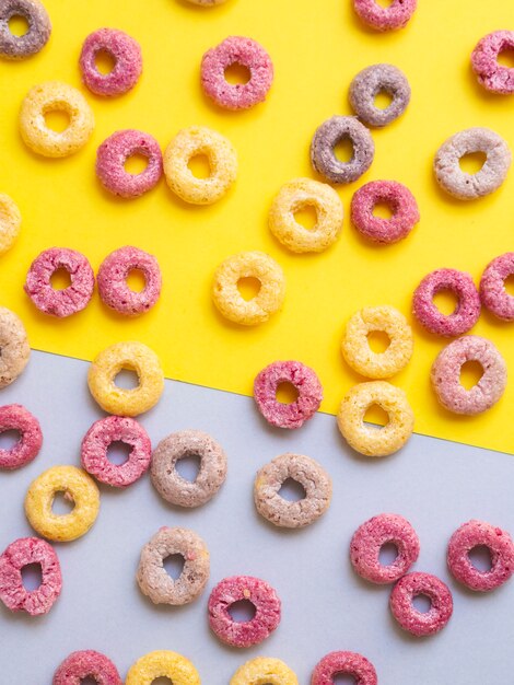 Multicoloured cereals with fruity on contrasted background