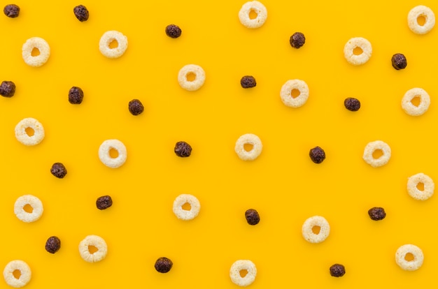 Multicoloured cereals with fruity on orange background