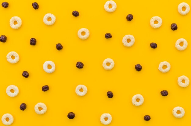 Multicoloured cereals with fruity on orange background