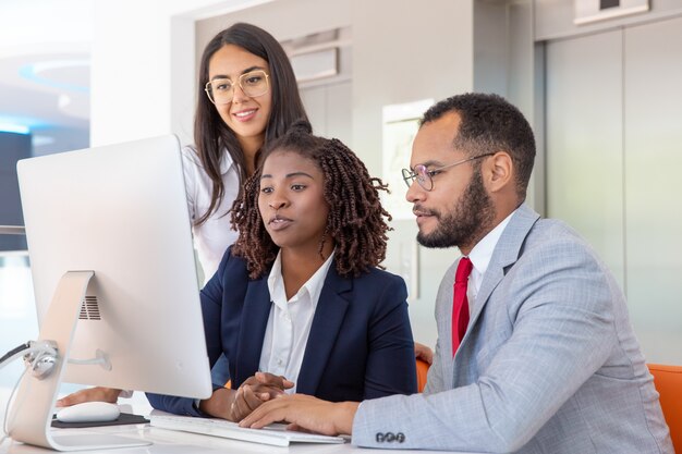 Multiethnic business colleagues using computer