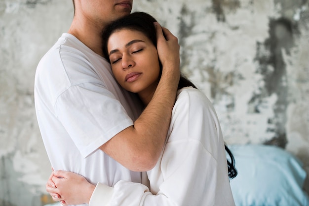 Multiethnic couple hugging each other