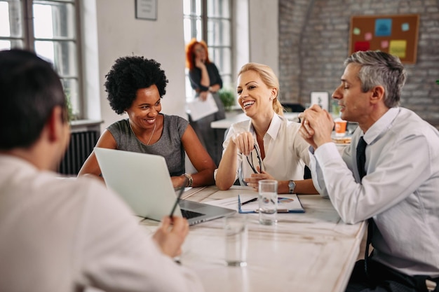 Free photo multiethnic group of happy business people having a meeting in modern office