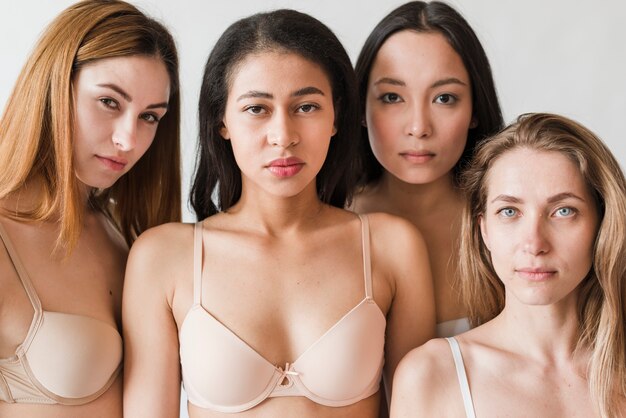 Multiethnic serious young women wearing bras looking at camera