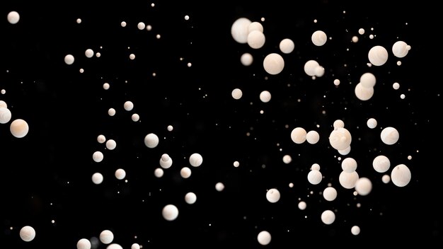 Multiple abstract acrylic balls in water on black background