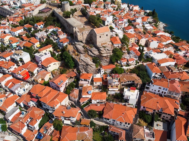Multiple buildings with orange roofs and fort, Kavala, Greece