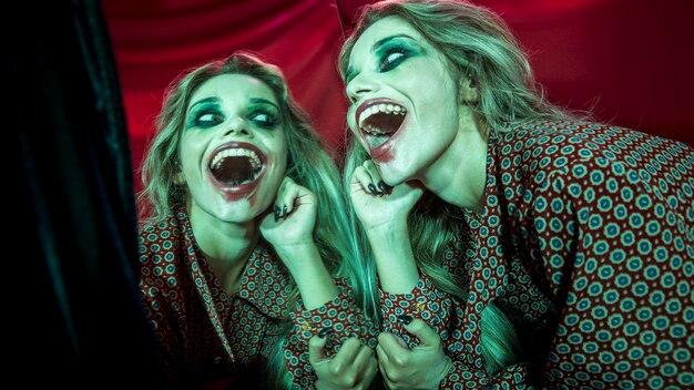 Free photo multiple mirror effect of woman having a creepy laugh