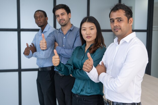 Multiracial business group posing in meeting room.
