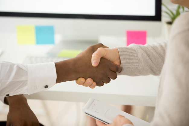 Multiracial business handshake as concept of help support in teamwork