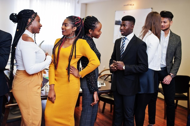 Multiracial business people standing at office and discuss together diverse group of employees in formal wear