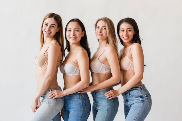 Free photo multiracial group of happy women posing in bras