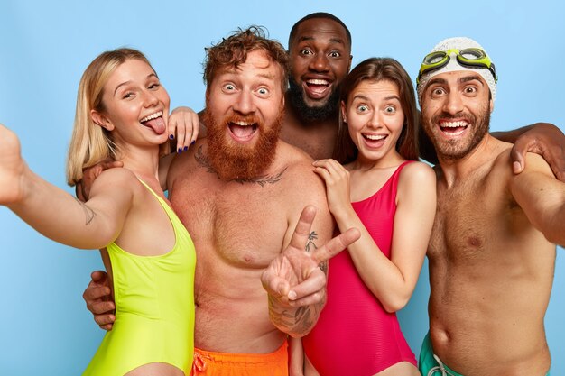 Multiracial group of young friends posing at the beach