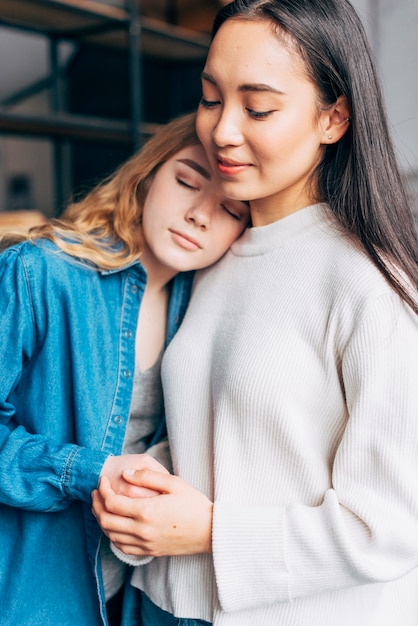 Multiracial lesbian couple hugging