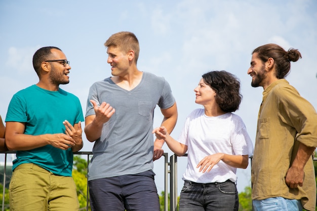 Multiracial people talking outdoors