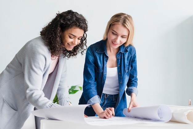 Multiracial smiling employees working with papers