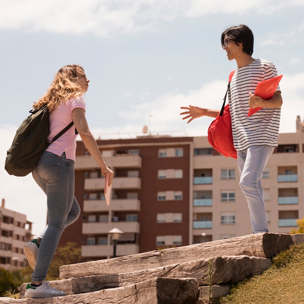 Multiracial students on street stairs in sunlight