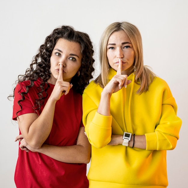 Multiracial women doing the silence sign