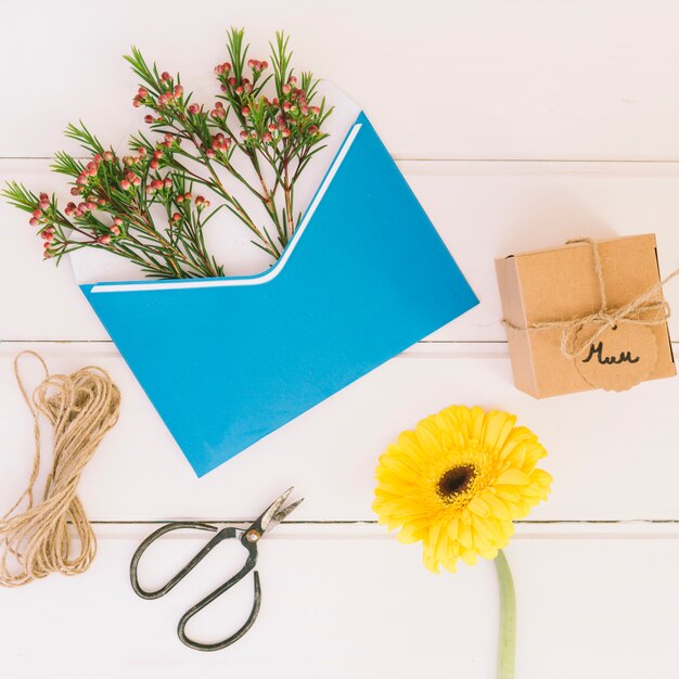 Mum inscription with gift, gerbera and envelope