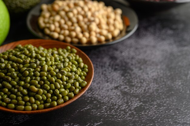 Mung bean and Soy bean on the plate on a black cement floor surface.