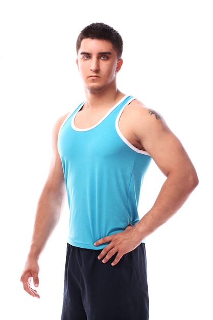 Muscular guy posing over white background