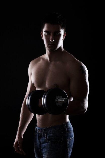 Muscular guy with dumbbell