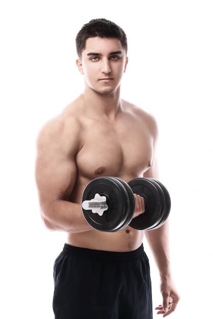 Muscular guy working out with dumbbell