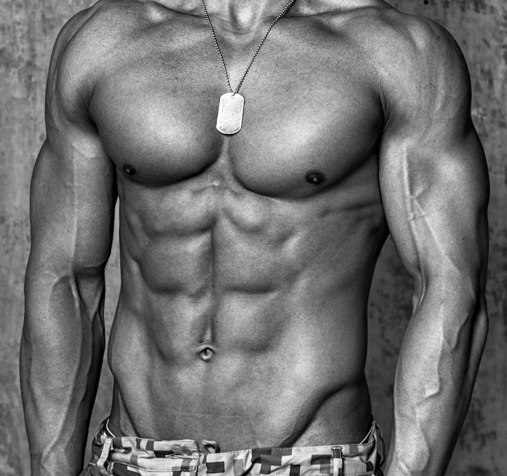 Free Photo muscular male body over the wall.